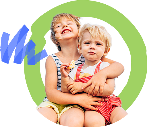 Two children smiling and sitting together, one holding a cracker, against a colorful, abstract background.