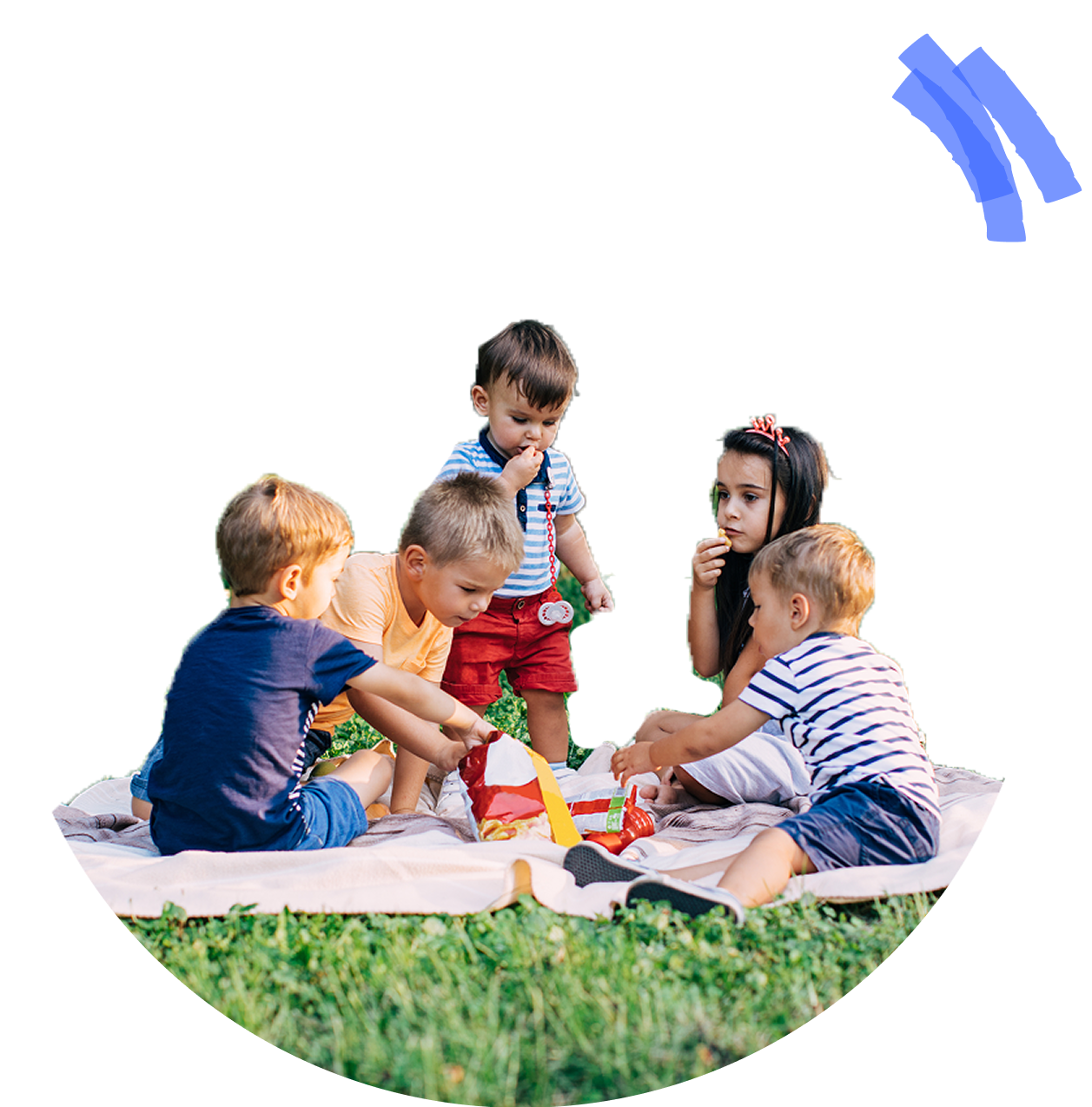Children are sitting on a blanket on the grass, playing with toys and enjoying a picnic.